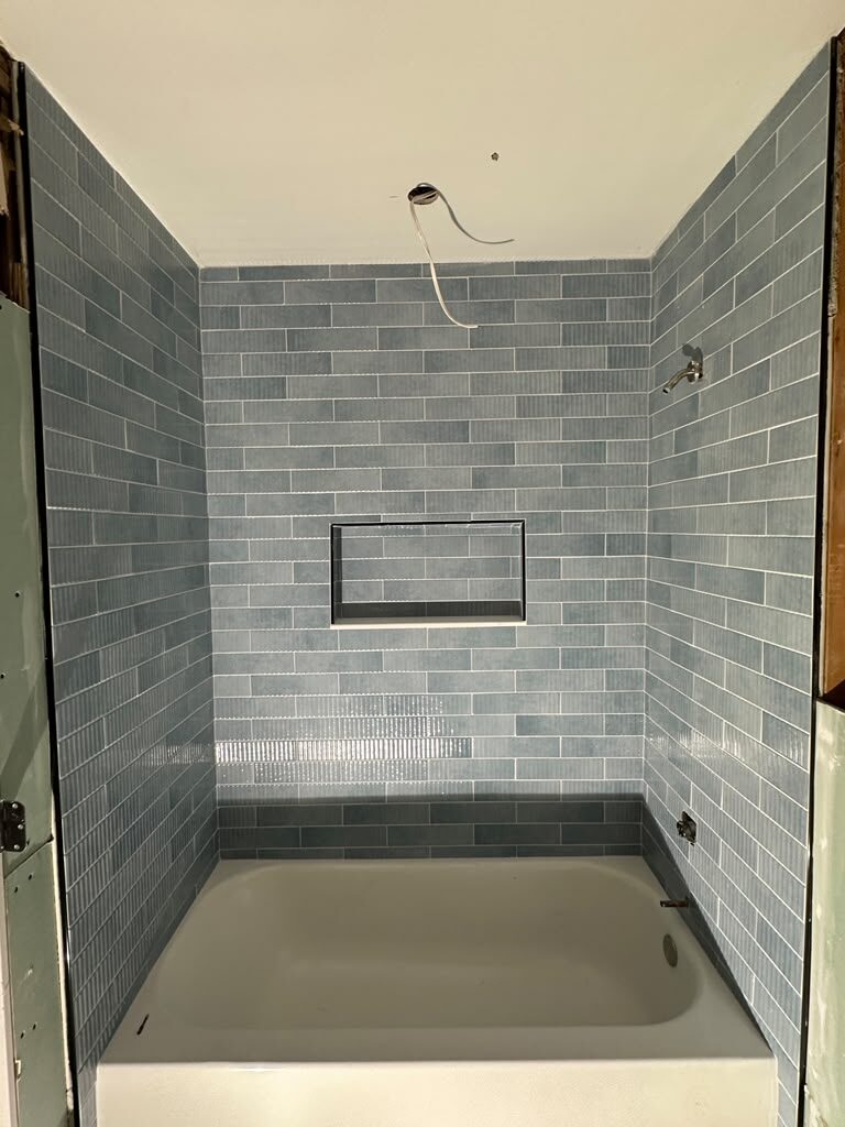 Blue subway tile tub surround