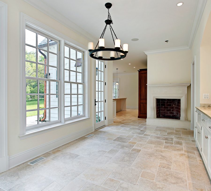 Stone tile floor running through a living room to French doors