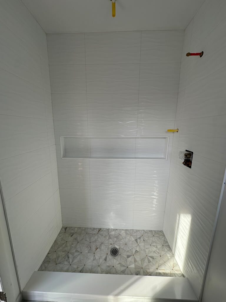 Walk-in shower with wave tile and mosaic floor